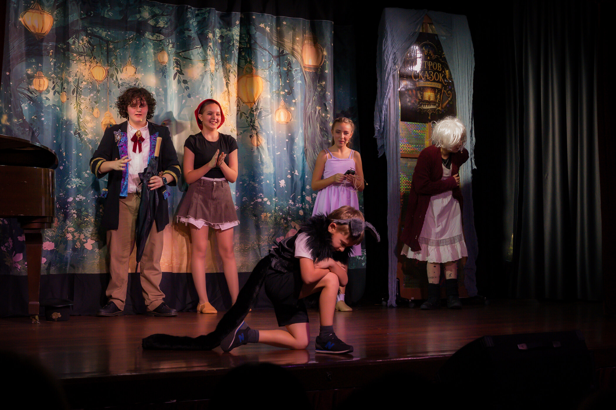 Full cast in costume performing a fairy-tale scene on stage