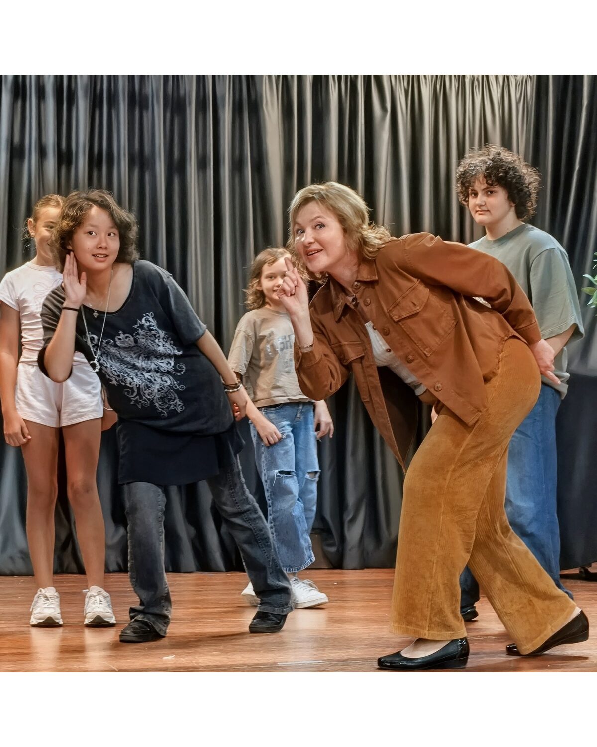 Natalie Mitz sharing a playful, candid moment with students backstage